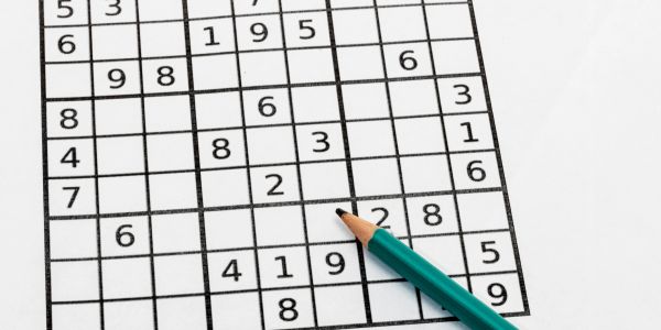 Pencil on a partially completed Sudoku puzzle.