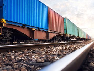 Cargo train with colorful containers on a track.