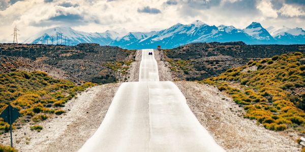 A long road streching toward the horizon, symbolizing movement, adaptatiion, and a life shaped by re