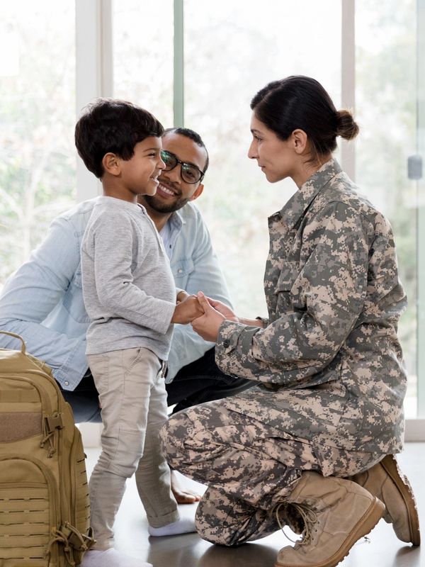 A soldier reconnecting with her child and partner at home.