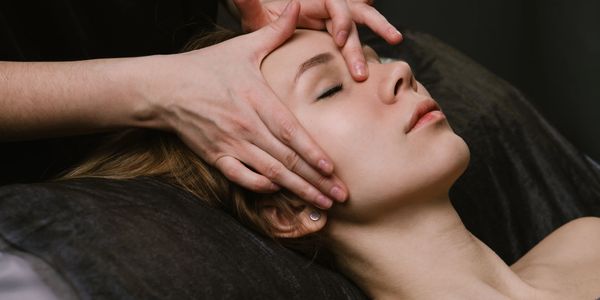 Woman receiving a facial massage.