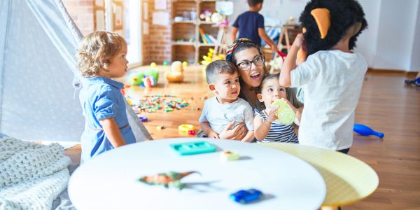 Adult and children playing together indoors.