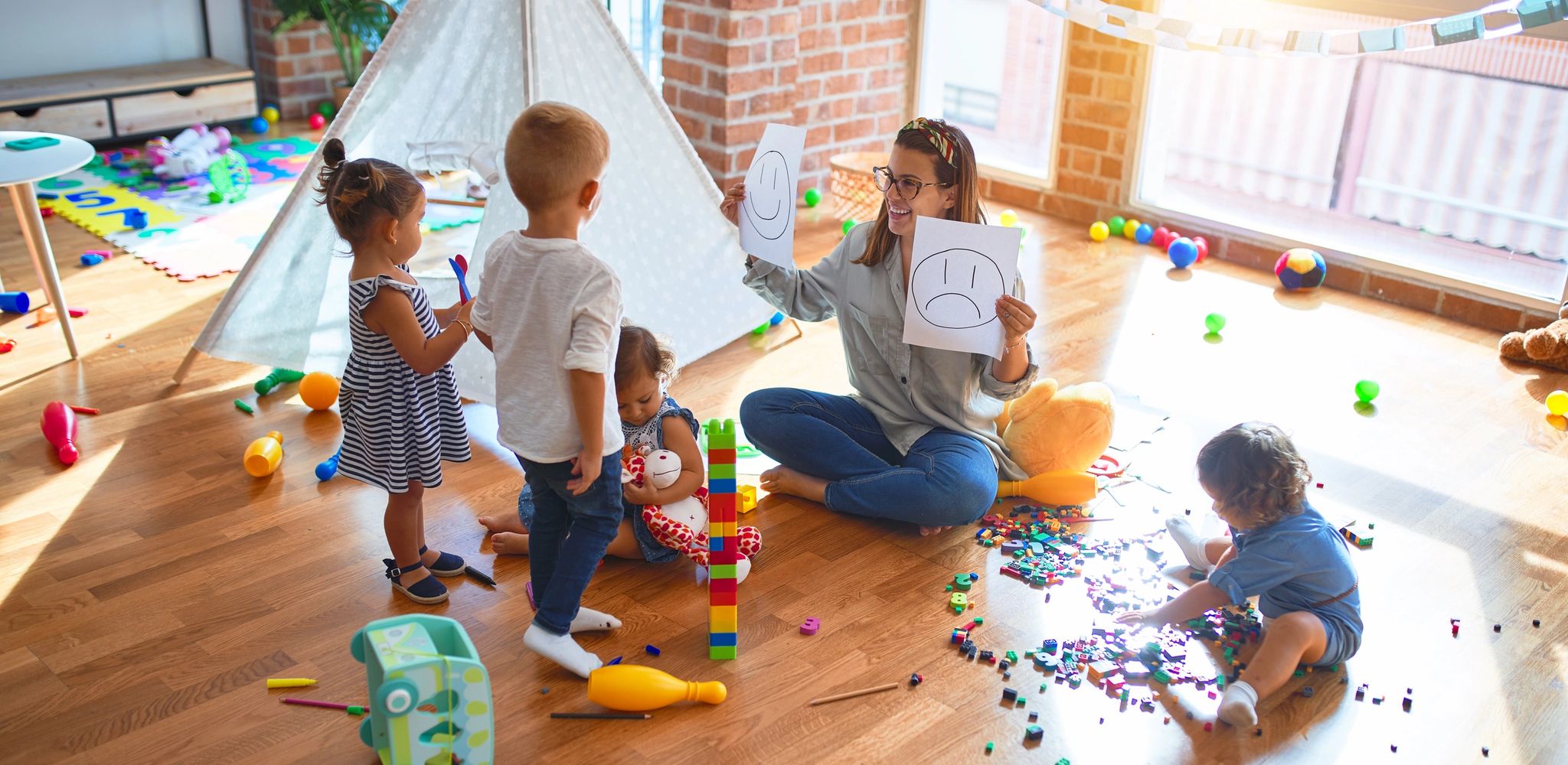 Teacher and kids in a Montessori Class setting studying 