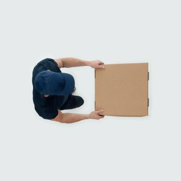 Delivery person holding a cardboard box, viewed from above.