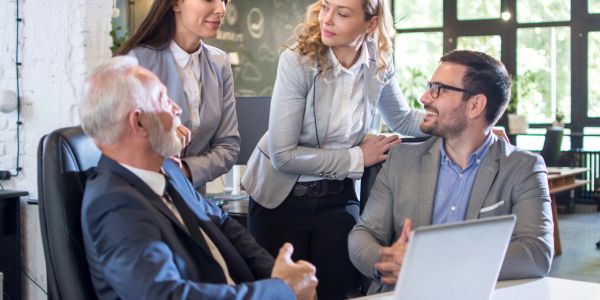 Four professionals in a business meeting.