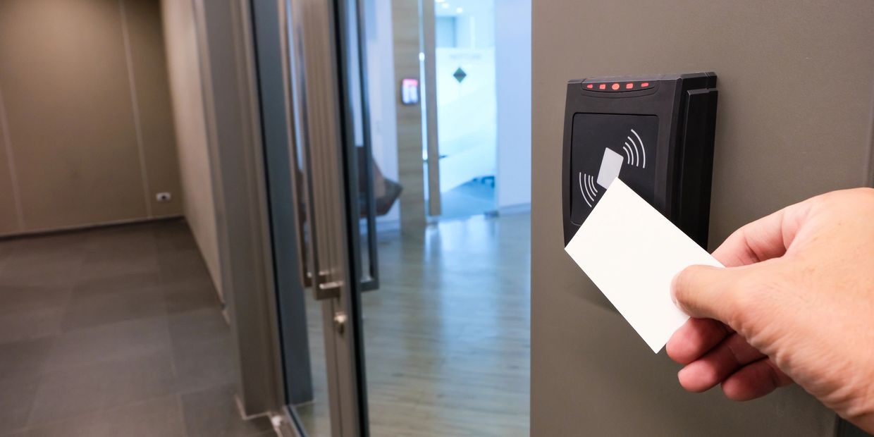 A person using a keycard on an access controlled door