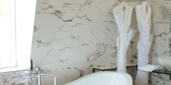 Modern Freestanding Bathtub in a Marble Bathroom

