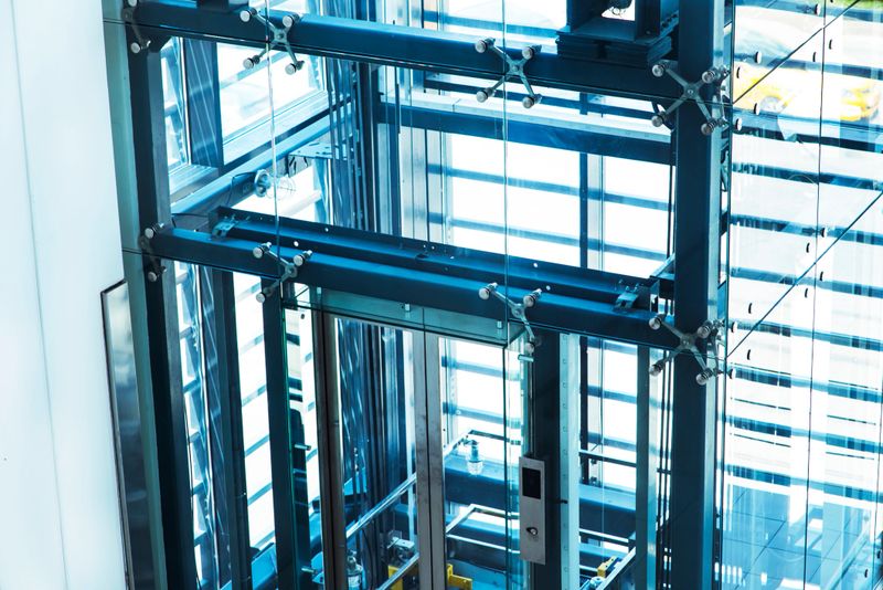 Modern elevator made of steel and transparent glass