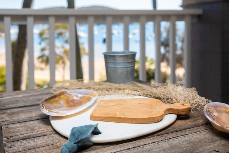 Rustic coastal beach style table with nautical items