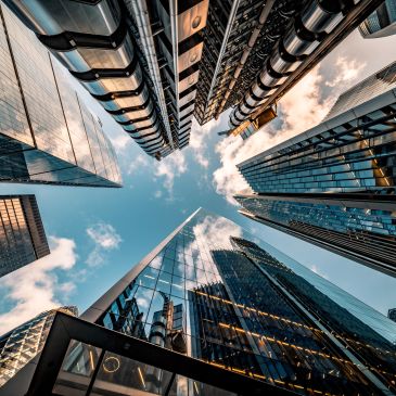 Modern skyscrapers towering against a blue sky with clouds.
