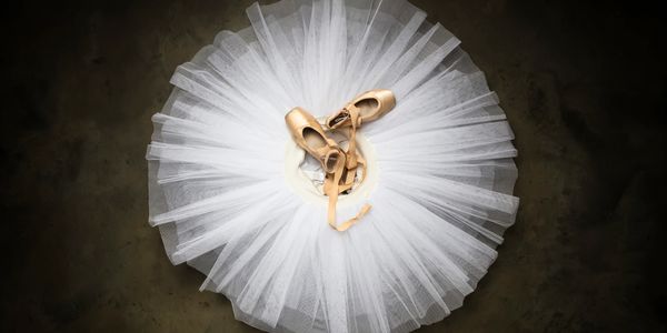 Pointe Shoes sitting on White Tutu