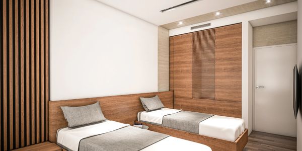 Modern bedroom with twin wooden beds and minimalist design.