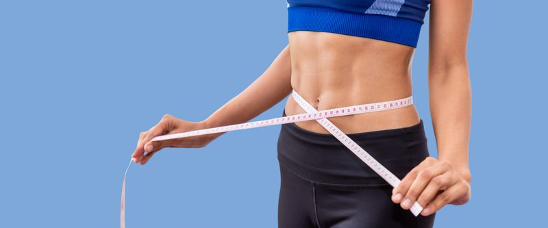 Attractive female woman torso with measuring tape, weight control and dieting concept