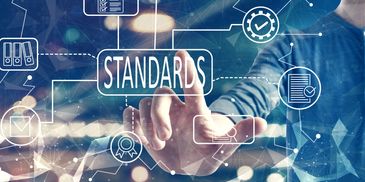 Person interacting with digital interface illustrating standards and compliance icons.