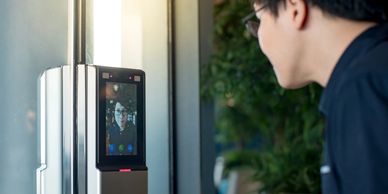 Person using facial recognition on a device.
