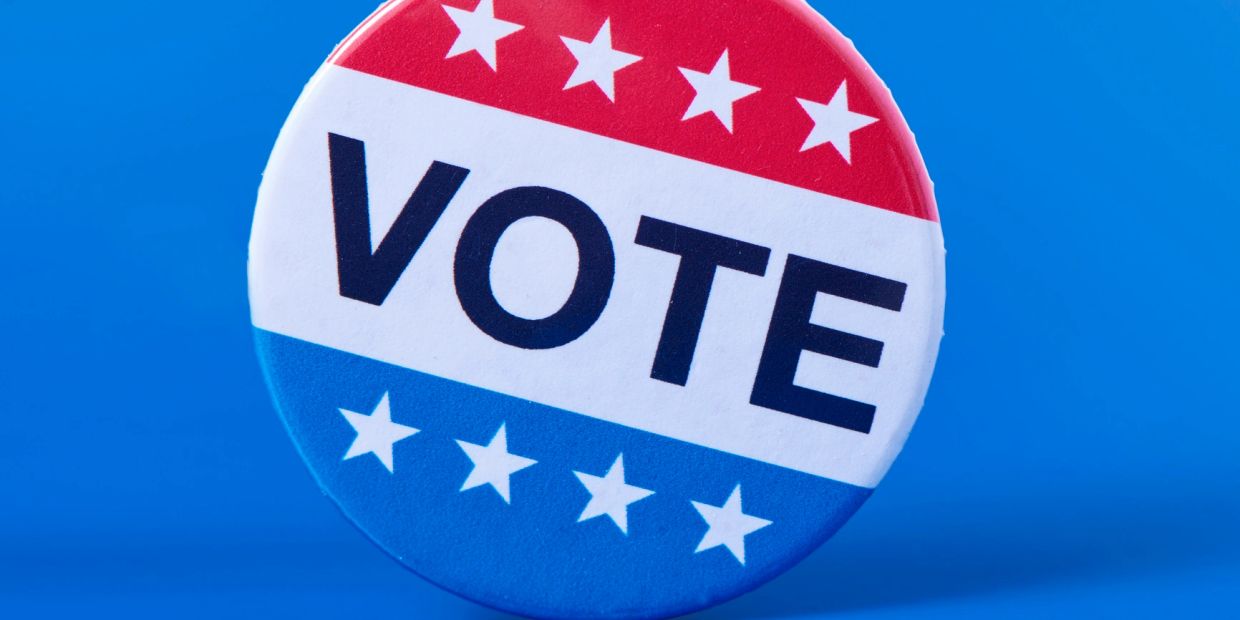A patriotic voting button with stars and the word VOTE.