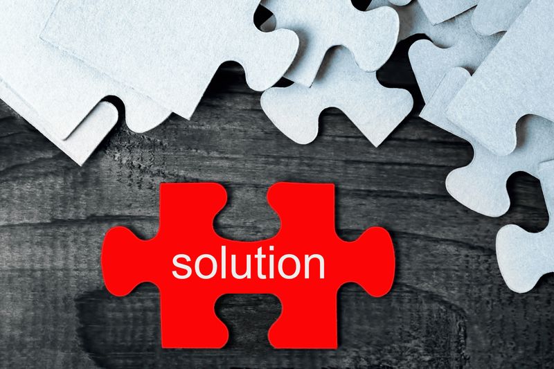 Jigsaw puzzles on a wooden table. The concept of solving problems.
