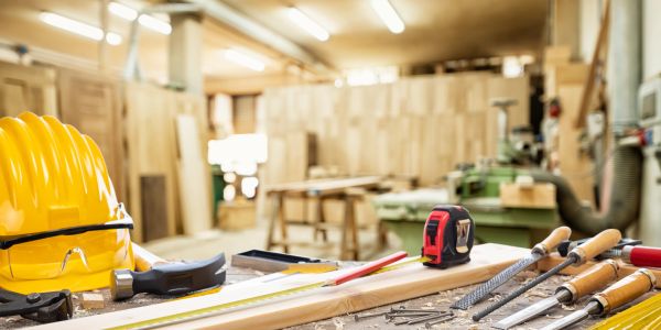 Woodworking tools and safety gear in a workshop.