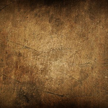 Close-up of a worn, textured rusty metal surface with scratches.