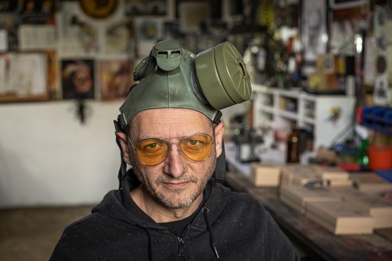 Portrait of a craftsman wearing glasses in his workshop