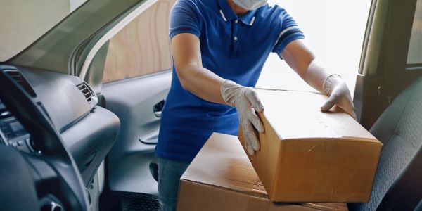 Person loading boxes into a car.