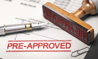 A pre-approved stamp on paper with a pen.