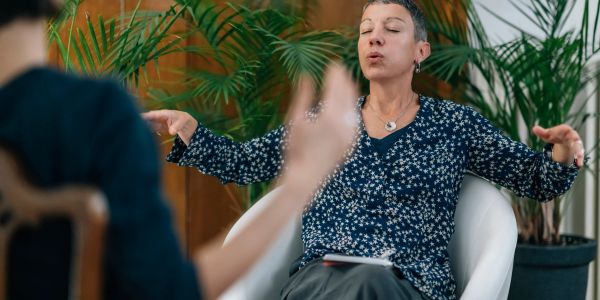 Woman speaking expressively during a conversation.