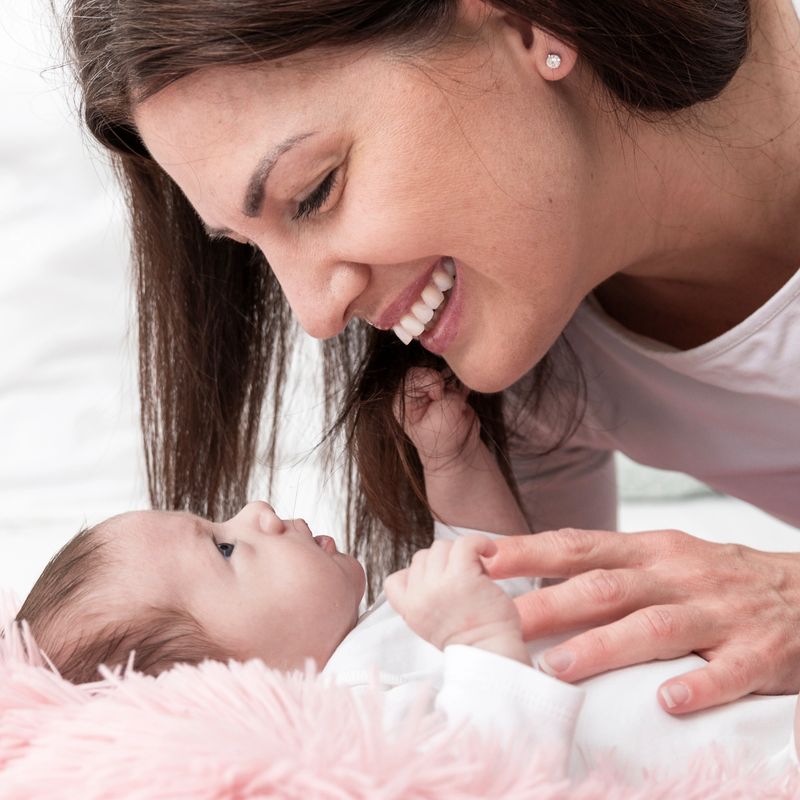 Young mother bonding with her baby girl