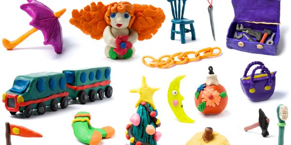 Colorful clay models of various objects including a train, Christmas tree, and umbrella.