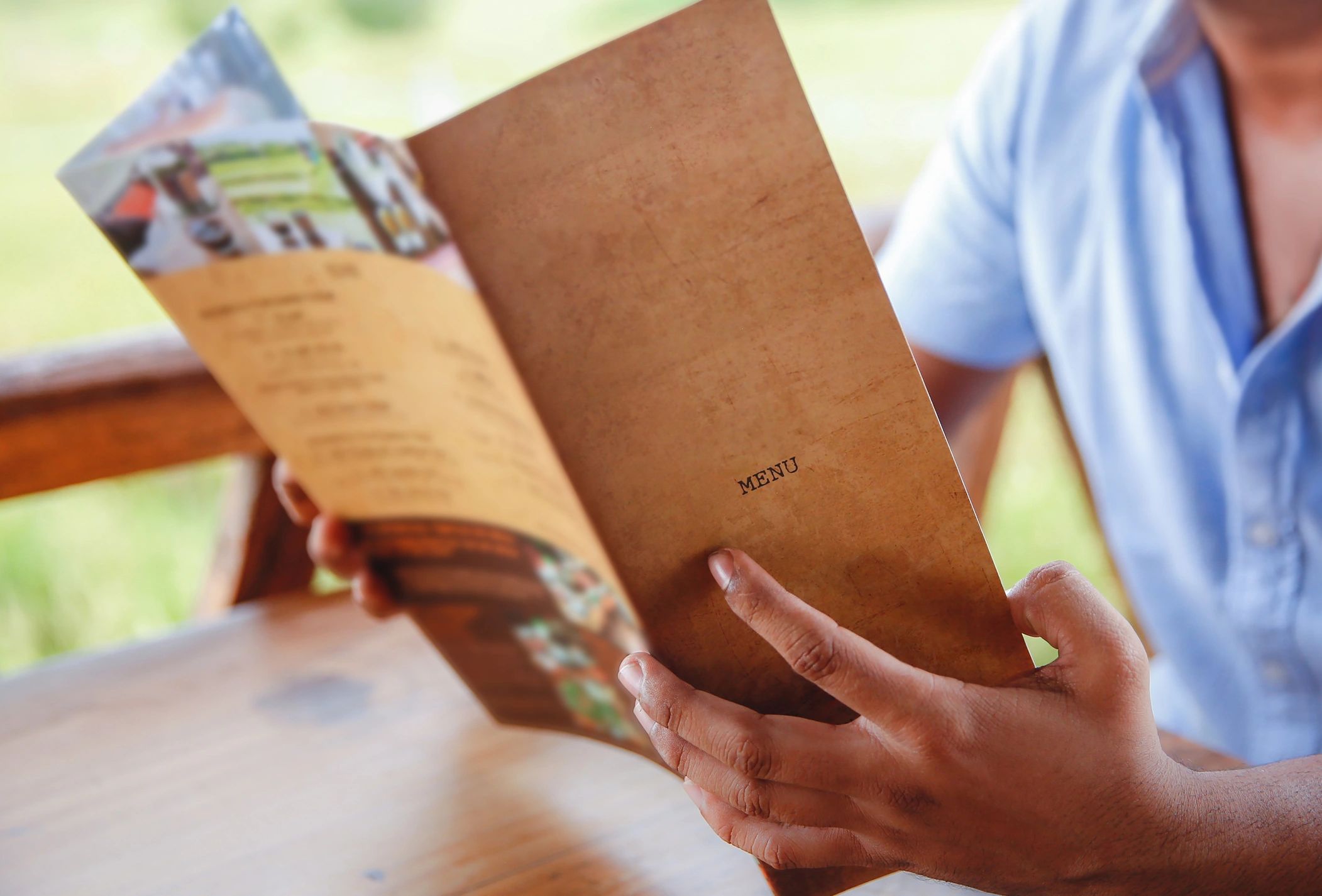 Man holding and reading a menu.