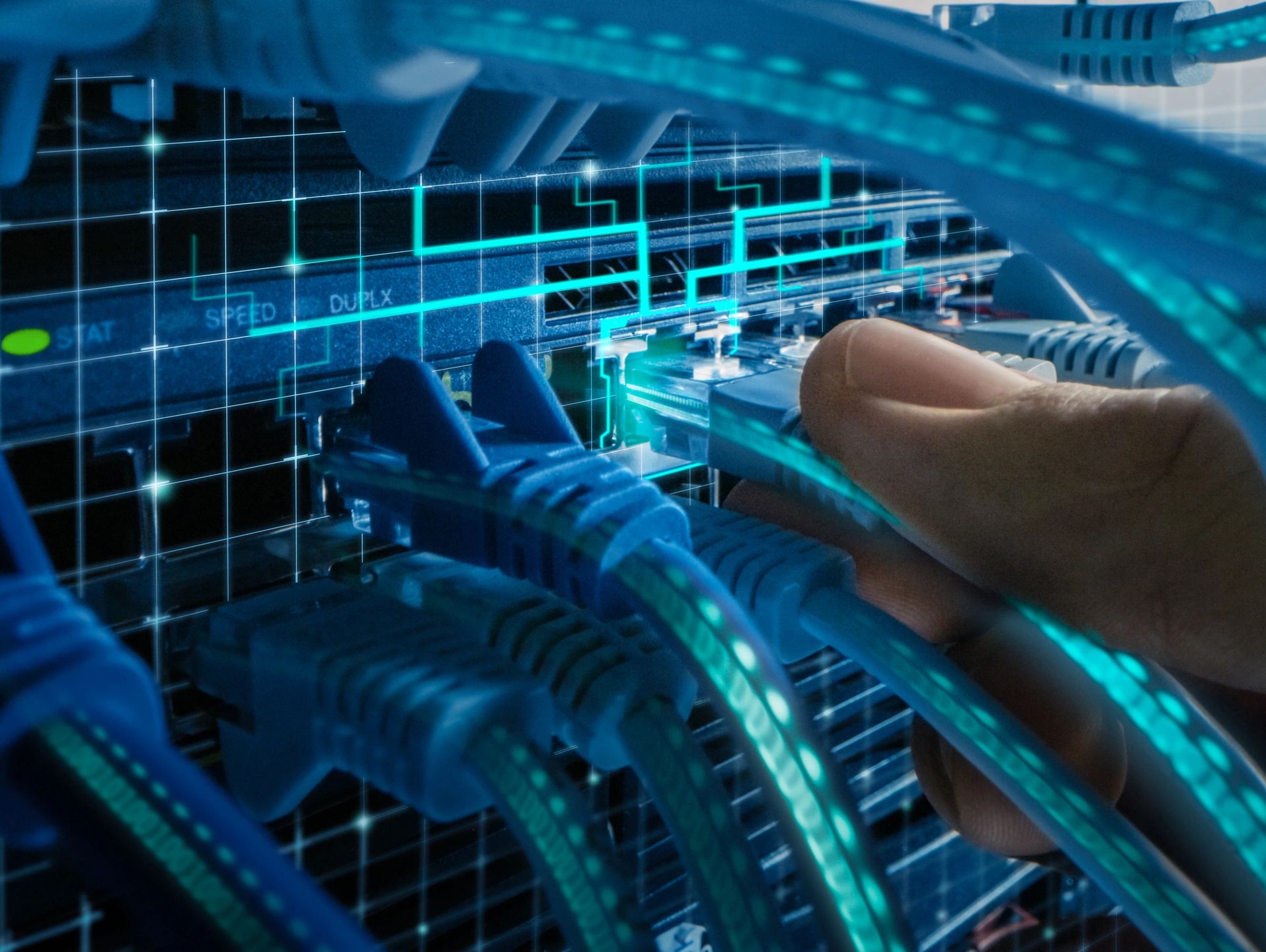 Hand plugging an Ethernet cable into a network switch with digital overlay.