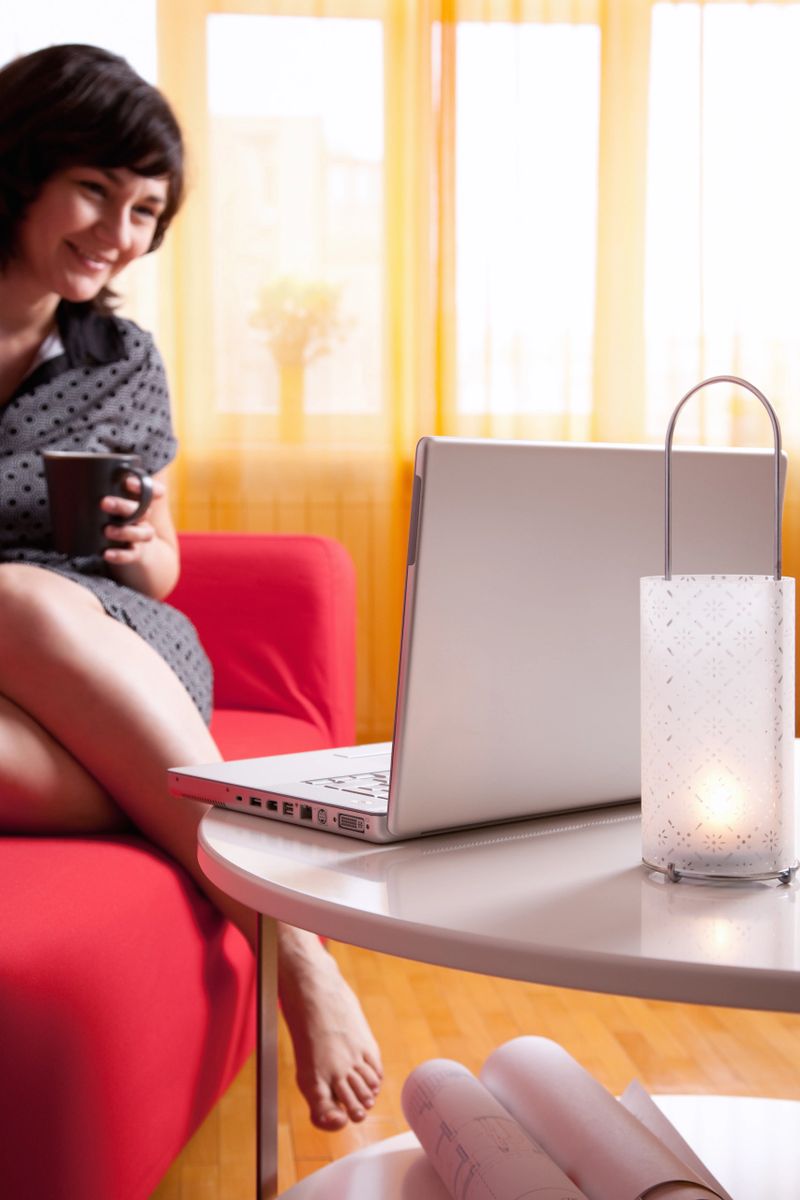 Cosy afternoon at home, girl with a laptop.