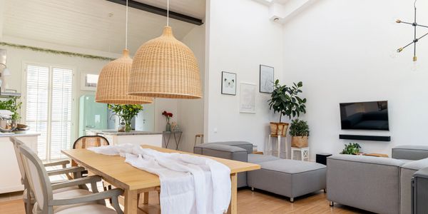 Bright, modern open living and dining area with natural wood and gray accents.