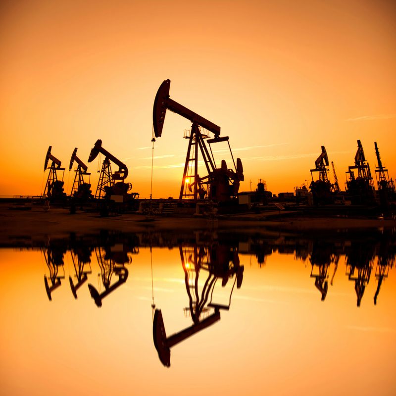 Oil pumps and rig at sunset
