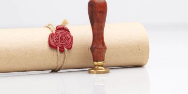 A rolled parchment sealed with red wax and a wooden stamp.