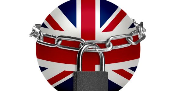 Union Jack sphere locked with chain and padlock symbolizing restriction.