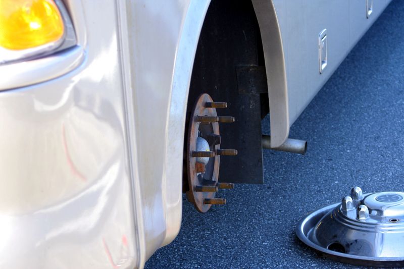 A flat tire on an RV has to be changed on the roadside.  
