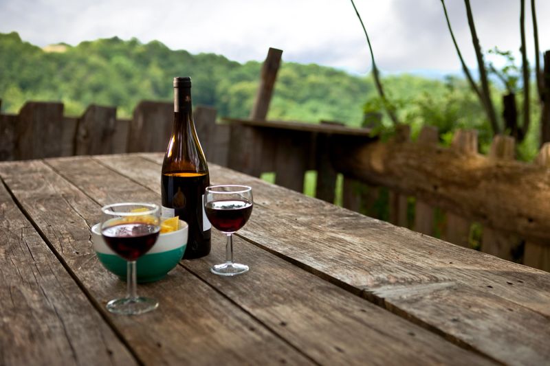 Bottle and glasses of wine on a wooden table