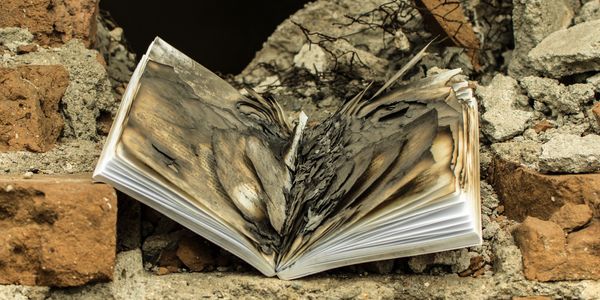Burned school book representing Walnut Valley Women's Club philanthropy