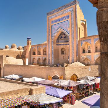 tashkent uzbekistan Historic market and mosque with intricate tilework under clear blue sky.