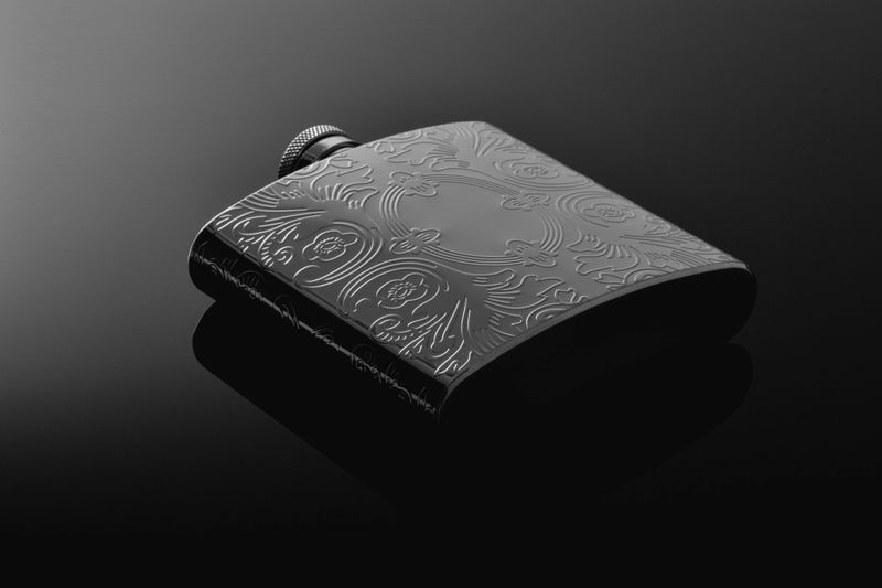 Custom engraved stainless steel flask showcasing intricate laser designs