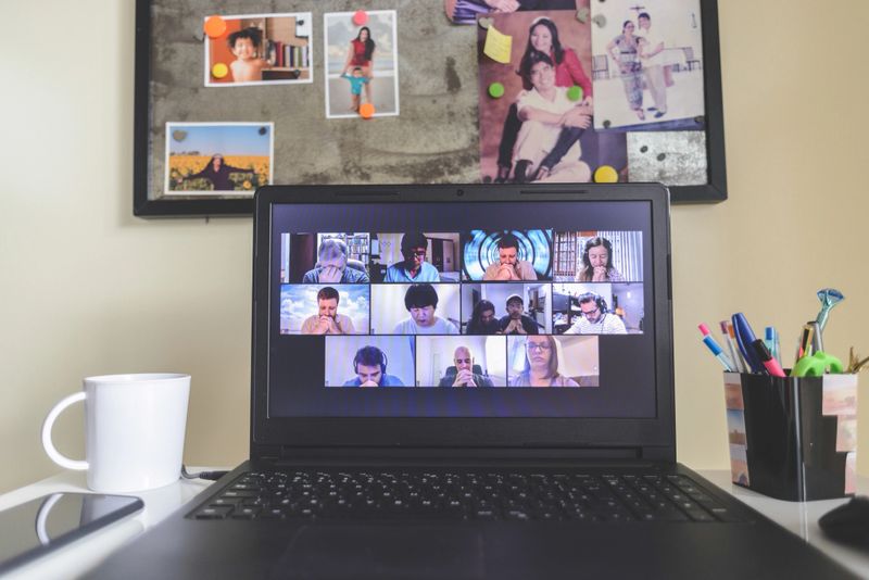 Multi-ethnic group of people online praying together in a video conference