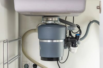 Modern kitchen garbage disposal unit under sink.
