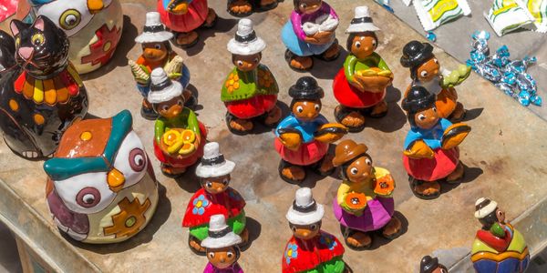 Colorful ceramic figurines on a table.