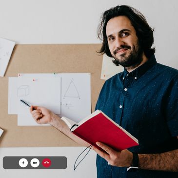 Man smiling while using laptop at home.