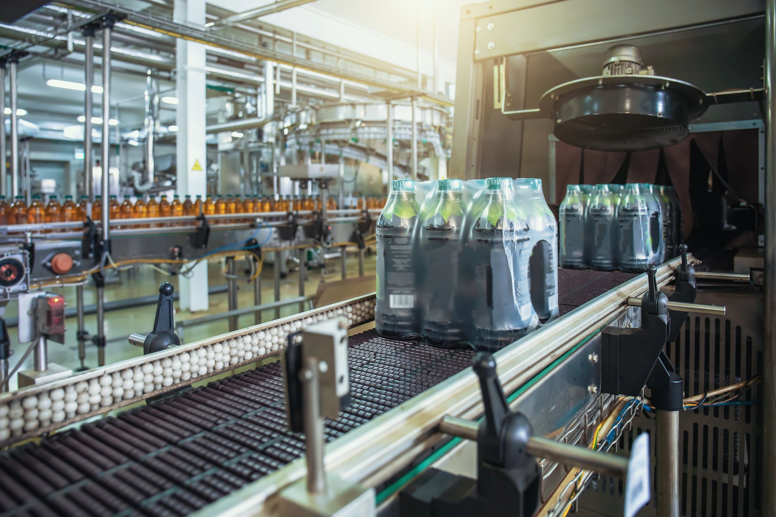 Beverage bottles on a production line in a factory.