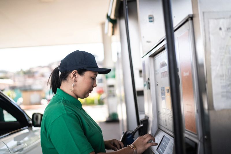 Female gas station attendant working