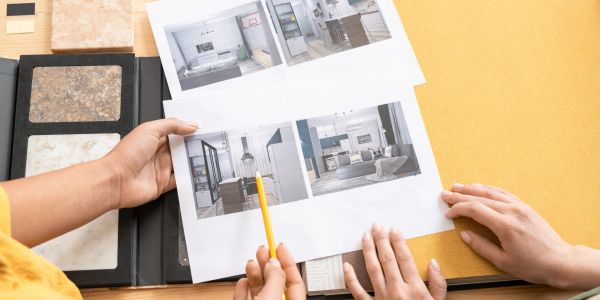 People reviewing interior design photos and materials for a project.