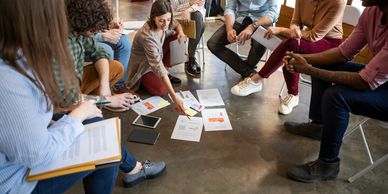 group of adults sitting and brainstorming
