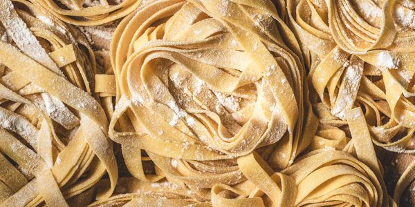 Fresh homemade pasta nests dusted with flour.
